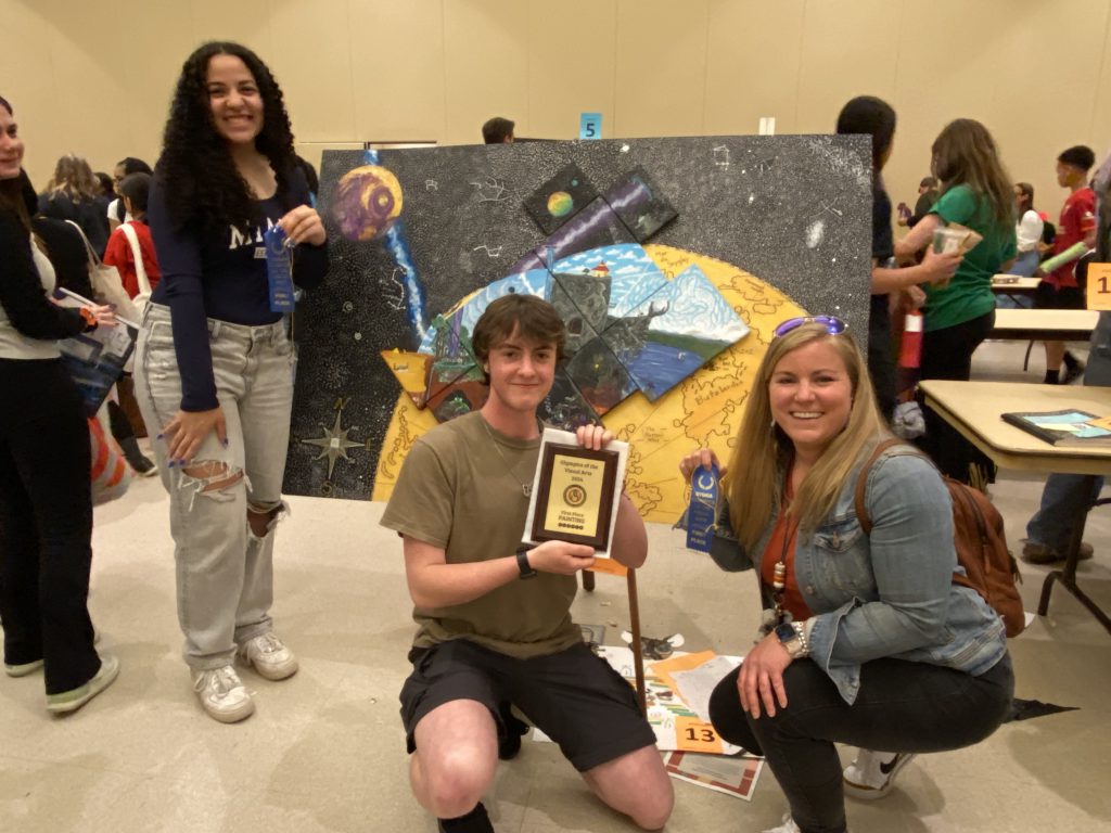 Isabelle Flint, Rahe Lulla and Kirsten O'Brien with the winning painting