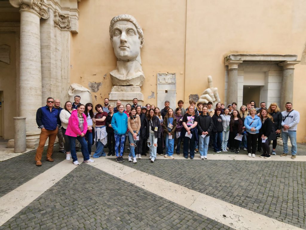 Latin students, chaperones and parents posing for a picture in Italy